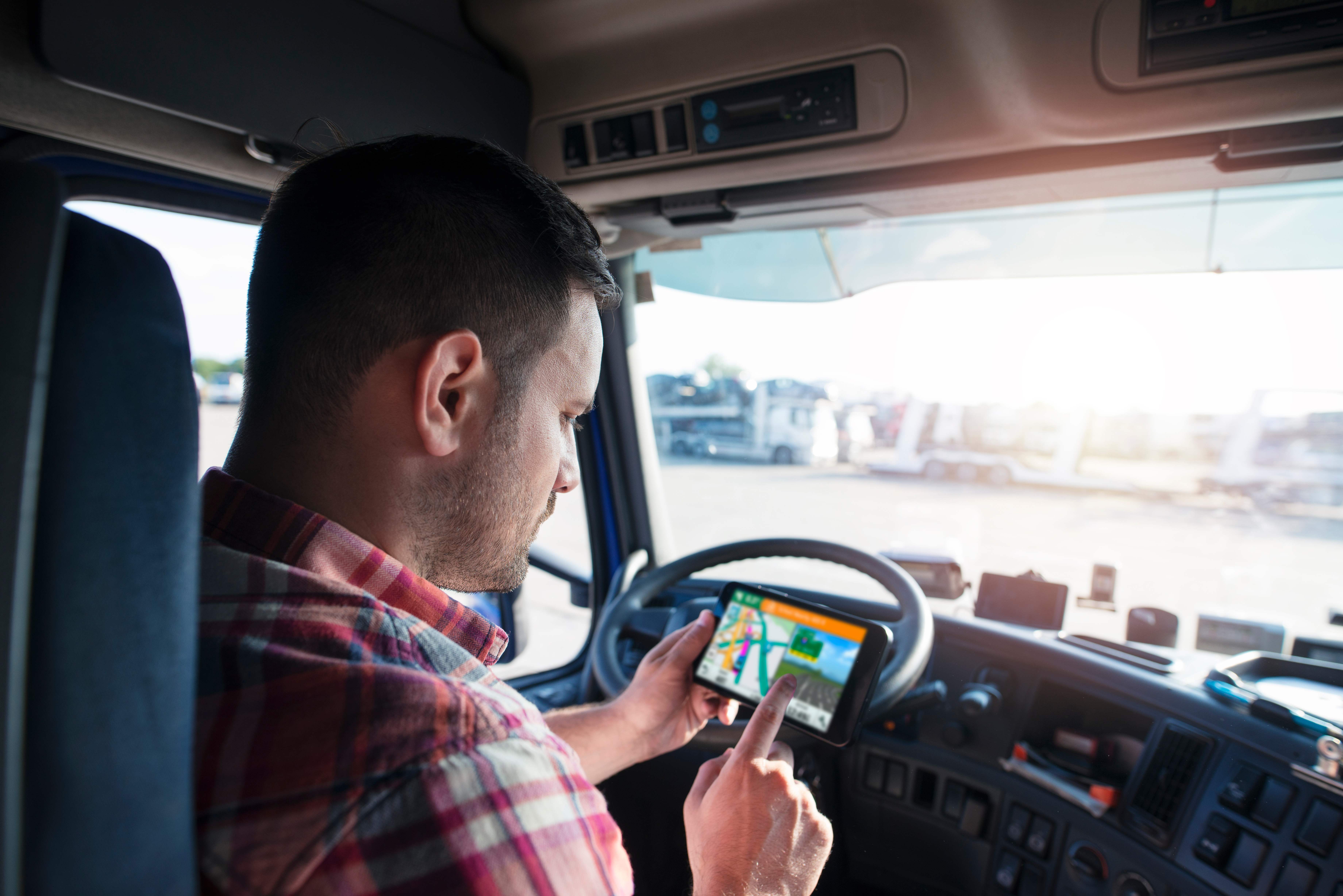 HGV driver using his phone for directions while stationary.